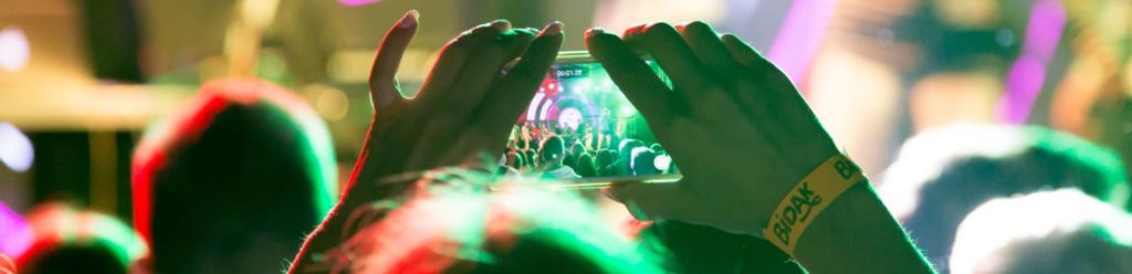person taking picture at concert