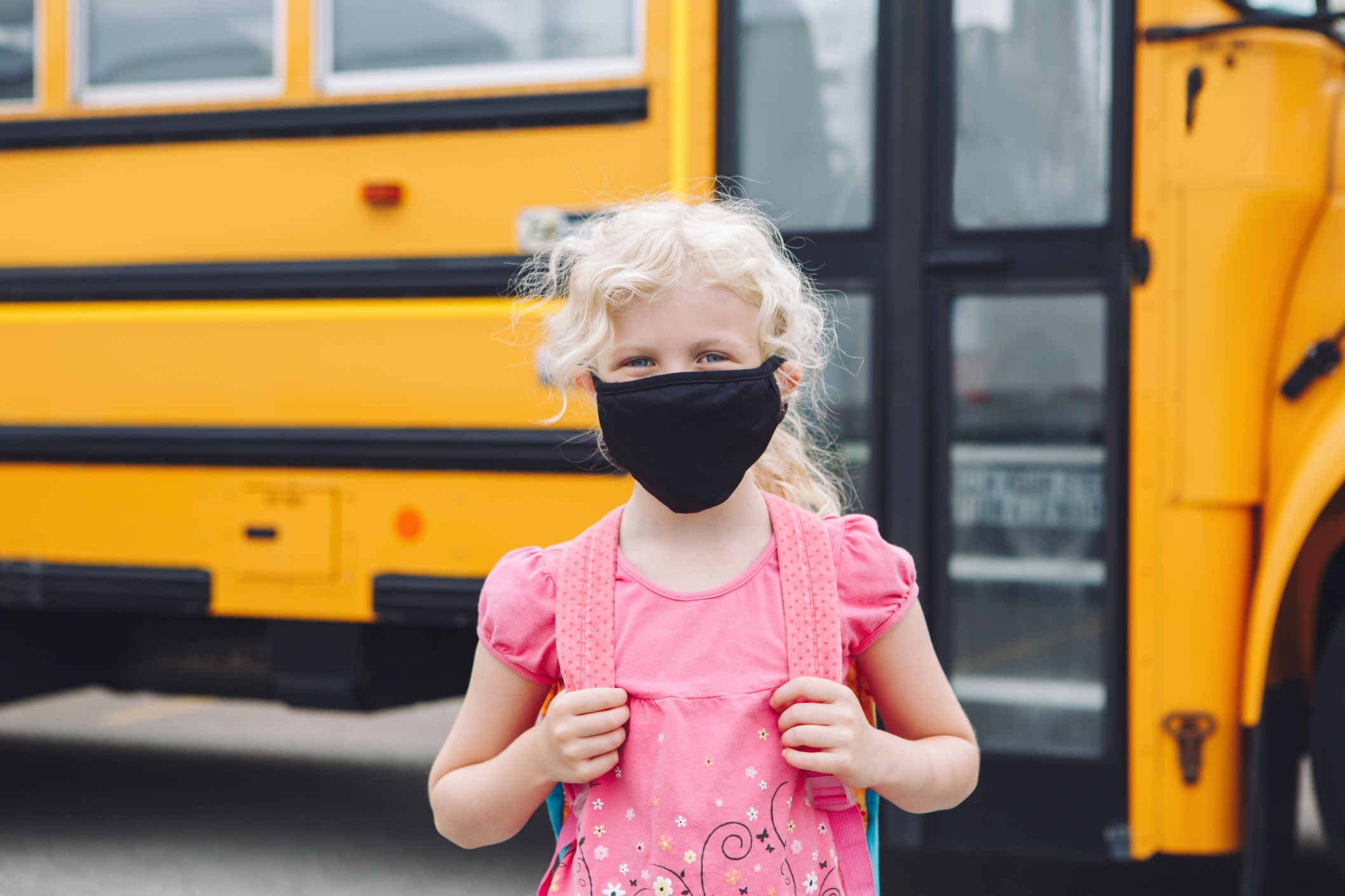 Illustrating the importance of understanding COVID-19 data to keep your family healthy. Image is school-age child with mask